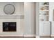 Living room with fireplace, custom built-ins, and white painted brick at 5509 Cliffwood Ct, Raleigh, NC 27609