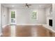Spacious living room with hardwood floors, a fireplace, and bright natural light at 5509 Cliffwood Ct, Raleigh, NC 27609