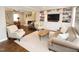 Spacious living room featuring hardwood floors, built-in shelves, a cozy fireplace, and comfortable seating arrangement at 5509 Cliffwood Ct, Raleigh, NC 27609