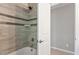 Shower with stylish horizontal tiling and sleek fixtures, with a glimpse of the adjacent room at 5509 Cliffwood Ct, Raleigh, NC 27609