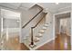 Classic staircase with wood railing, carpeted steps, and decorative trim, leading to the upper level of the home at 5509 Cliffwood Ct, Raleigh, NC 27609