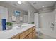 Well-lit bathroom featuring a single sink vanity, large mirror, and a shower-tub combination with tile surround at 5515 South Roxboro # 32, Durham, NC 27713