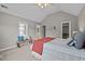 Bedroom with vaulted ceiling, carpet flooring, window, and view into bathroom and closet at 5515 South Roxboro # 32, Durham, NC 27713