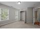Cozy bedroom featuring carpet flooring, two windows, and an open closet space with white door at 5515 South Roxboro # 32, Durham, NC 27713