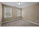 Bedroom with carpet, neutral walls, and two windows with blinds to provide natural light at 5515 South Roxboro # 32, Durham, NC 27713