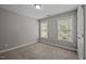 Neutral bedroom filled with natural light from two windows, carpet flooring and neutral wall paint at 5515 South Roxboro # 32, Durham, NC 27713