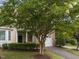 Charming townhome featuring a stone facade, attached garage and well-maintained landscaping at 5515 South Roxboro # 32, Durham, NC 27713