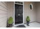 Elegant front door with decorative window and lush potted plants at 5515 South Roxboro # 32, Durham, NC 27713