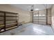 Spacious garage featuring ample storage shelves and a functional overhead door at 5515 South Roxboro # 32, Durham, NC 27713