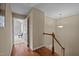Second floor hallway with hardwood floors, leading into a carpeted room with natural light at 5515 South Roxboro # 32, Durham, NC 27713