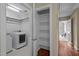 Functional laundry room equipped with a washer, dryer, and ample shelving space for storage at 5515 South Roxboro # 32, Durham, NC 27713