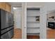Open pantry with shelving for food and supply storage, with kitchen and living space views at 5515 South Roxboro # 32, Durham, NC 27713