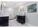 Bright bathroom with double sinks, a soaking tub, and elegant fixtures creates spa-like feel at 5900 Holly Dr, Raleigh, NC 27616