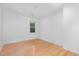 Minimal bedroom features hardwood floors, bright lighting, and a bright, window view at 5900 Holly Dr, Raleigh, NC 27616