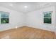 Well lit bedroom with beautiful hardwood floors and view to the private backyard at 5900 Holly Dr, Raleigh, NC 27616