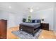 Bright primary bedroom with a ceiling fan, and hardwood floors, offering serene retreat at 5900 Holly Dr, Raleigh, NC 27616