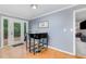 Cozy dining area with modern table set offers view to the outdoor deck through glass doors at 5900 Holly Dr, Raleigh, NC 27616