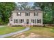 Charming two-story home featuring classic curb appeal with symmetrical windows and a well-maintained front yard at 5900 Holly Dr, Raleigh, NC 27616
