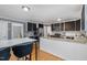Modern kitchen with stainless steel appliances, granite countertops, and contrasting cabinetry at 5900 Holly Dr, Raleigh, NC 27616
