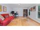 Spacious living room featuring hardwood floors, bright lighting, and tasteful decorative artwork at 5900 Holly Dr, Raleigh, NC 27616