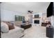 Spacious living room featuring a fireplace, large sectional, and a mounted television at 5900 Holly Dr, Raleigh, NC 27616