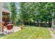 Spacious backyard with lush lawn and mature trees perfect for relaxation and outdoor activities at 6 Tulip Tree Ct, Durham, NC 27712
