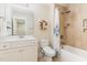 Well-lit bathroom showcases a shower-tub combo, single sink vanity and designer shelving at 6 Tulip Tree Ct, Durham, NC 27712