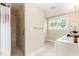 Bright bathroom with a step-in shower, single sink vanity and a window for natural light at 6 Tulip Tree Ct, Durham, NC 27712