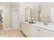 Bright bathroom features a dual sink vanity with quartz countertop, and decorative backsplash at 6 Tulip Tree Ct, Durham, NC 27712