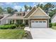 Charming home with stone accents, a two-car garage, and a beautifully landscaped front yard at 6 Tulip Tree Ct, Durham, NC 27712