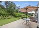 Relaxing backyard featuring patio furniture, well-maintained lawn, and lush greenery, perfect for outdoor enjoyment at 605 Smallwood Dr, Durham, NC 27703