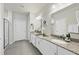 Bright bathroom featuring double vanities, granite countertops, and modern fixtures at 605 Smallwood Dr, Durham, NC 27703