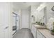Modern bathroom with double sinks, granite countertops, and tiled floor and walk in shower at 605 Smallwood Dr, Durham, NC 27703