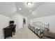 Neutral bedroom with a cozy daybed, desk, and an open door to an adjoining space at 605 Smallwood Dr, Durham, NC 27703