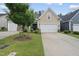 Charming single-Gathering home featuring a well-maintained lawn and attached two-car garage at 605 Smallwood Dr, Durham, NC 27703