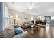 Open-concept living room with hardwood floors connecting to dining area and kitchen at 605 Smallwood Dr, Durham, NC 27703