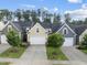 Attractive townhomes with well-manicured lawns and mature trees offer curb appeal at 605 Smallwood Dr, Durham, NC 27703