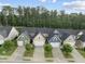 Charming townhomes with colorful exteriors, lush trees, and private driveways offer inviting curb appeal at 605 Smallwood Dr, Durham, NC 27703