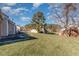 Spacious backyard featuring a well-maintained lawn and view of neighboring houses at 61 Fashion Pl, Durham, NC 27705