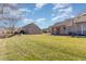 Large backyard featuring lush lawn and view of neighboring townhomes at 61 Fashion Pl, Durham, NC 27705