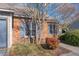 Brick townhome featuring tidy landscaping and blue shutters at 61 Fashion Pl, Durham, NC 27705