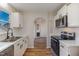 Well lit kitchen with white cabinets, stainless steel appliances, and hardwood floors at 61 Fashion Pl, Durham, NC 27705