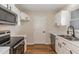 Clean kitchen with white cabinets, stainless steel appliances, and hardwood floors at 61 Fashion Pl, Durham, NC 27705