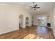 Bright, open living room with hardwood floors, arched doorway, and sliding glass doors at 61 Fashion Pl, Durham, NC 27705