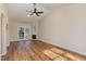 Bright living room with vaulted ceilings, modern flooring, and sliding glass door to patio at 61 Fashion Pl, Durham, NC 27705