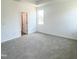 Bright bedroom featuring neutral carpet and a door that leads to the hallway at 67 Furley St., Homesite 117, Sanford, NC 27330
