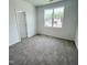 Bright bedroom with carpeted floor and a large window at 67 Furley St., Homesite 117, Sanford, NC 27330