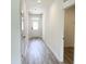 Hallway with grey wood-look flooring, white walls and white doors and trim at 67 Furley St., Homesite 117, Sanford, NC 27330