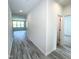 Hallway with grey wood-look flooring, white walls leads to living area at 67 Furley St., Homesite 117, Sanford, NC 27330