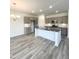 Open-concept kitchen featuring a central island and stainless steel appliances at 67 Furley St., Homesite 117, Sanford, NC 27330